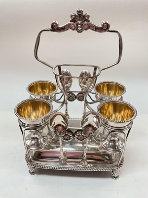 Lot 1078 - Victorian silver plated four person egg cup set on stand with four silver teaspoons