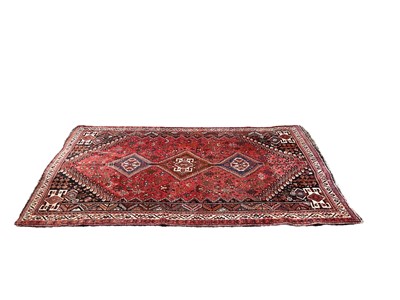 Lot 1335 - Eastern rug with three central medallions on red, blue and cream ground, 258cm x 168cm