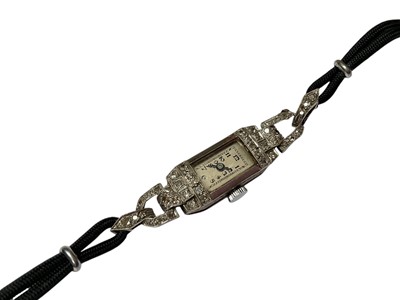 Lot 95 - Art Deco diamond set cocktail watch on black cord bracelet, in box