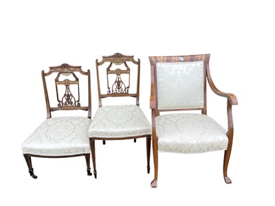Lot 1380 - Two Victorian inlaid rosewood chairs with cream upholstered seats together with another elbow chair with matching upholstery (3)