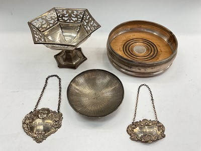 Lot 1115 - Silver wine coaster, pieced silver pedestal dish, silver pin dish and two silver spirit labels