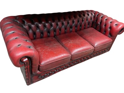 Lot 1390 - Victorian style oxblood leather three seater chesterfield