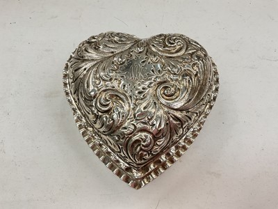 Lot 1127 - Sterling silver heart shaped jewellery box with embossed foliate scroll decoration