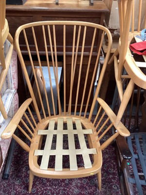 Lot 1439 - Two Ercol high back elbow chairs and a footstool (3)
