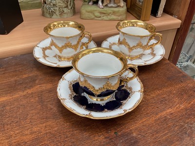 Lot 129 - Three Meissen gilt moulded breakfast cups and saucers, the saucers 15.75cm diameter