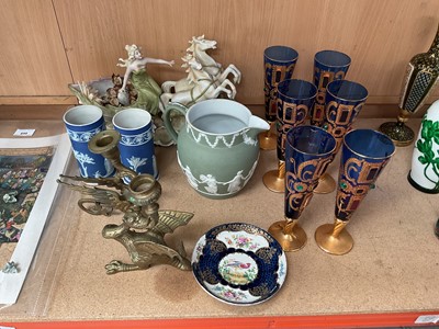 Lot 830 - Set of six jewel-encrusted wine glasses, 19th century Wedgwood jasperware vases and jug, a continental figural vase, pair of brass candlesticks, and a Booths saucer