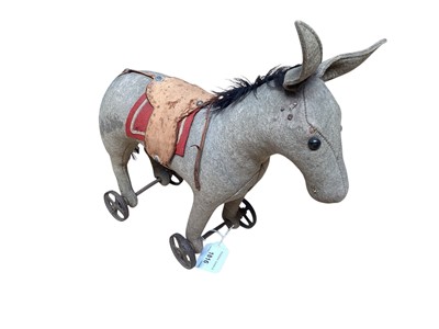 Lot 1816 - Early felt pull-a-long horse thought to be Steiff. Height to ear tip 30cms.
