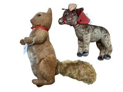 Lot 1819 - Early mohair squirrel, possible Steiff, boot button eyes, stitched claws to paws and feet, silent squeaker in belly, red ribbon, head swivels, limbs and tail move plus a small velvet and felt do...