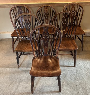Lot 1576 - Set of six 19th century elm wheelback chairs, with solid seats, on turned legs joined by stretchers