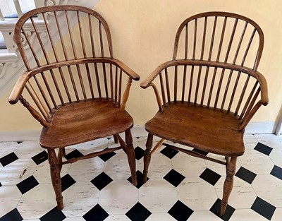 Lot 1577 - Near pair of 19th century elm stick back elbow chairs, with solid seats, on turned legs joined by castors
