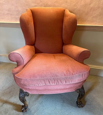 Lot 1298 - Georgian-style wing armchair on carved cabriole legs with claw and ball feet, upholstered in terracotta fabric