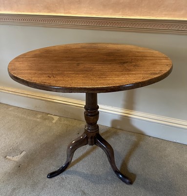 Lot 1580 - George III mahogany tripod table, the circular tilt top supported on a turned column and three splayed legs, 74cm diameter