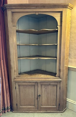 Lot 1582 - 19th century pine corner cupboard, the three shaped shelves above twin cupboard door below, on plinth base, 115cm wide x 183cm high