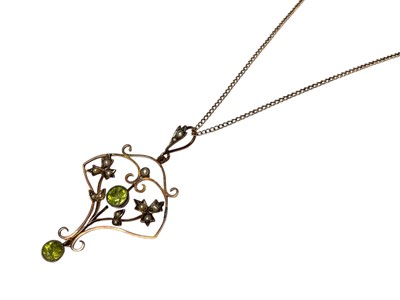 Lot 60 - Edwardian 9ct gold peridot and seed pearl open work scroll pendant on 9ct gold chain