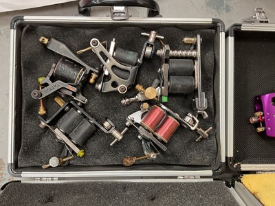 Lot 47 - Collection of tattooing equipment including machines/guns, flashes, books, etc