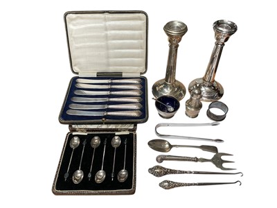 Lot 67 - Two similar silver candlesticks, set of six 1920s silver coffee bean end spoons in fitted case, set of six silver handled butter knives in fitted case, other silver items and flatware
