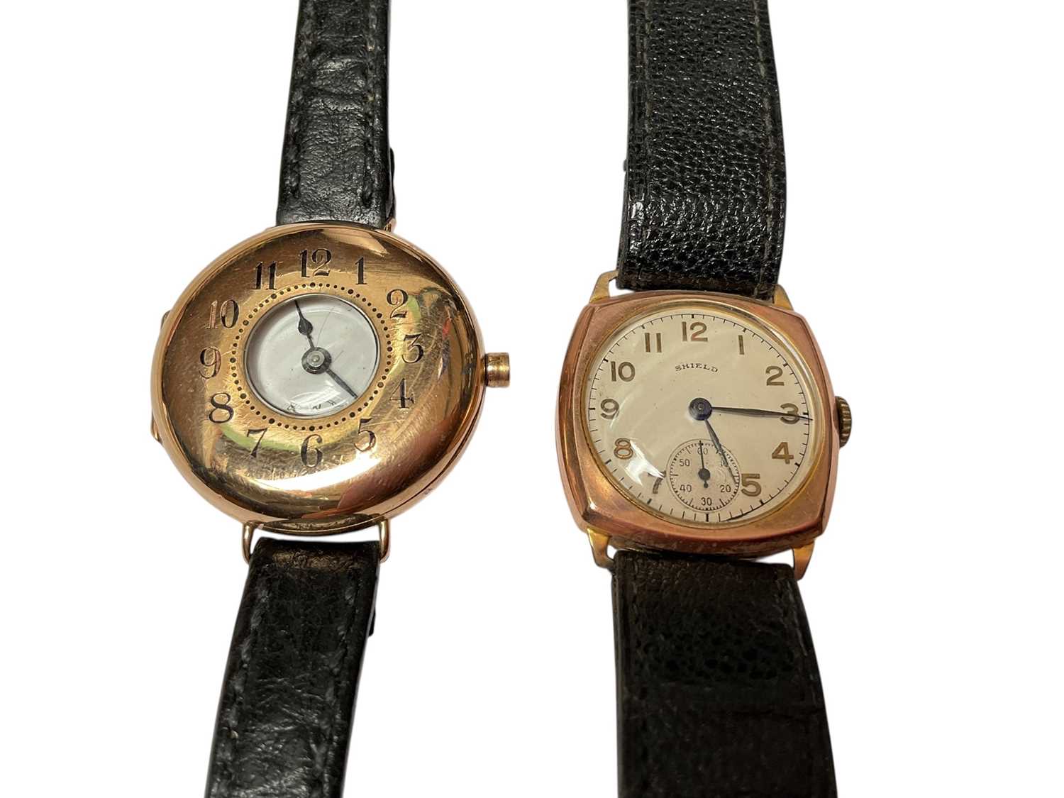 Lot 70 - 1920s 9ct gold cased half hunter wristwatch and one other 9ct gold cased Shield wristwatch, both on black leather straps