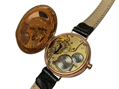 Lot 70 - 1920s 9ct gold cased half hunter wristwatch and one other 9ct gold cased Shield wristwatch, both on black leather straps