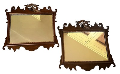 Lot 1586 - Pair of Georgian style Chippendale revival mahogany wall mirrors, with central gilt exotic bird, scroll moulded borders and gilt slip