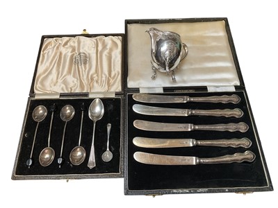 Lot 122 - Five 1930s silver butter knives, various silver spoons and a Continental silver (800) cream jug with engraved decoration