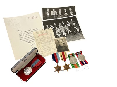 Lot 734 - Second World War medal group comprising 1939 - 1945 Star, Africa Star, Defence and War medals, together with an Elizabeth II Imperial Service medal named to Robert Hawkes, with some paperwork.