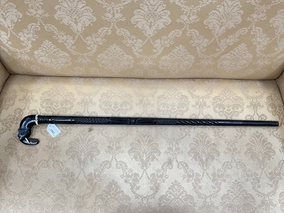 Lot 2565 - 19th century gentleman’s heavy one piece Ebony walking stick, with carved decoration and Elephant head handle with bone tusks, eyes and ferrule. 92cm overall length.