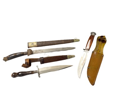 Lot 753 - Good quality early 20th century German hunting knife / dagger with steel blade, alloy cross guard and turned horn grip, in leather sheath with nickel plated chape, together with another German d...