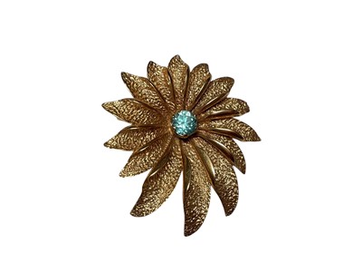 Lot 308 - 1960s 9ct gold stylised flower head brooch with a central blue zircon (London 1967), 45mm