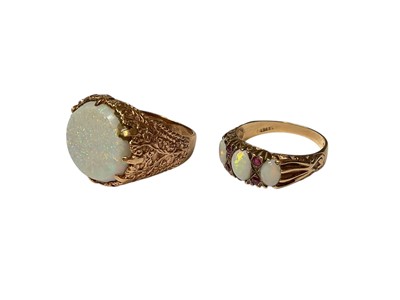 Lot 309 - 9ct gold large oval opal ring in carved gold scroll setting and 1970s opal three stone ring with ruby accents in carved 9ct gold setting (2)