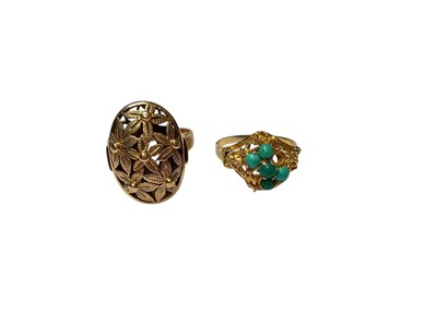 Lot 311 - Yellow metal pierced floral oval panel ring and yellow metal ring (stamped 750) turquoise cluster ring (two stones missing)