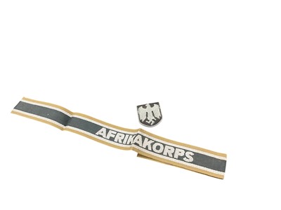 Lot 718 - Second World War Nazi German Afrikakorps cuff title, together with a Nazi cap badge, (2).