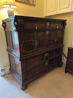 Lot 1262 - 17th century oak geometric chest with an arrangement of four long drawers, each with brass drop handles, on turned bun feet