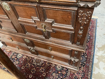 Lot 1262 - 17th century oak geometric chest with an arrangement of four long drawers, each with brass drop handles, on turned bun feet