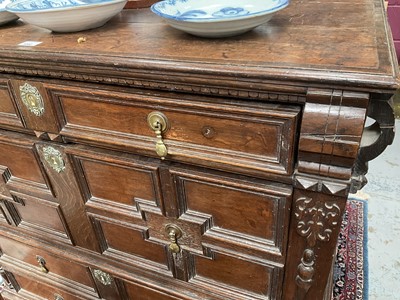 Lot 1262 - 17th century oak geometric chest with an arrangement of four long drawers, each with brass drop handles, on turned bun feet