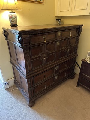 Lot 1262 - 17th century oak geometric chest with an arrangement of four long drawers, each with brass drop handles, on turned bun feet