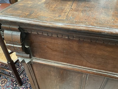 Lot 1262 - 17th century oak geometric chest with an arrangement of four long drawers, each with brass drop handles, on turned bun feet