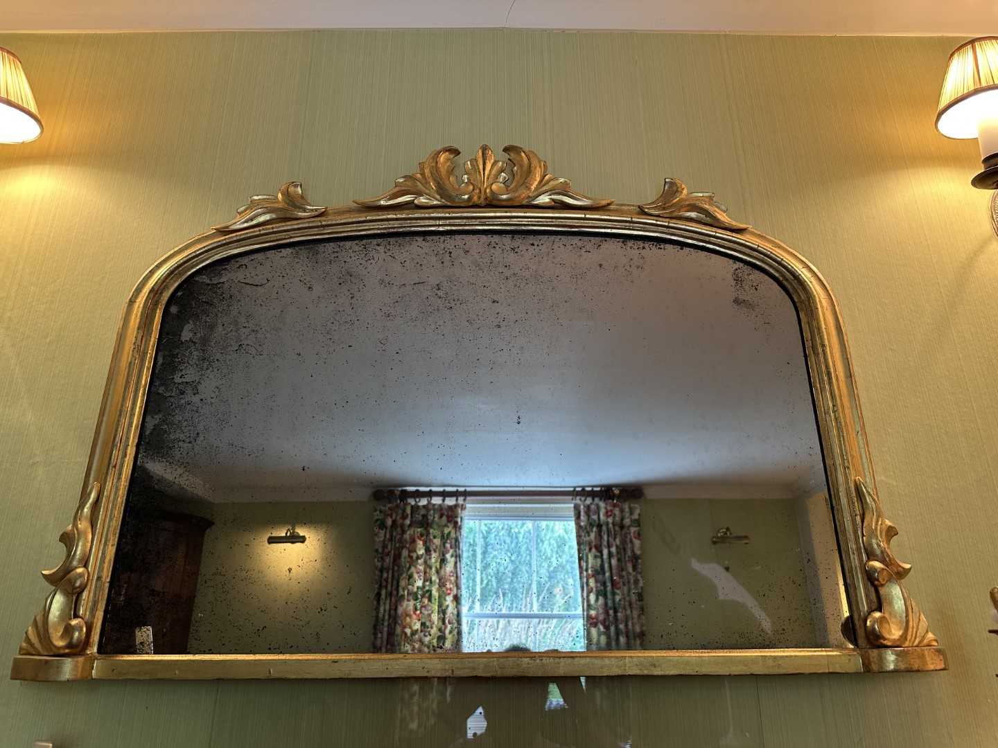 Lot 1267 - Victorian gilt framed wall mirror of arched form with foliate leaf cresting, 110cm wide x 74cm high
