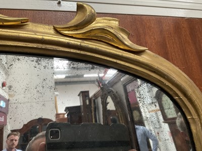 Lot 1267 - Victorian gilt framed wall mirror of arched form with foliate leaf cresting, 110cm wide x 74cm high