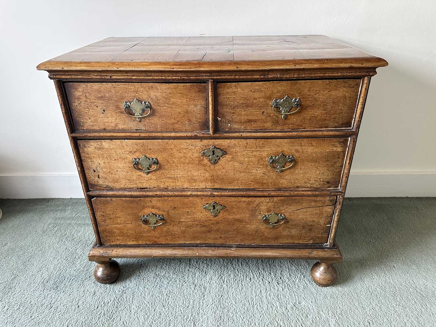 Lot 1273 - 18th century, and later, walnut chest of two short and two long drawers, with brass plate handles, on bun feet, 89cm wide x 53cm deep x 81cm high