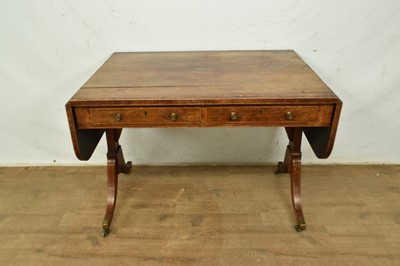 Lot 5310 - Regency rosewood sofa table with twin drawers, rounded drop flaps, on splayed legs and brass capped castors, 153cm wide overall