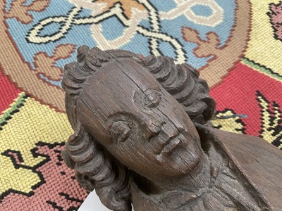 Lot 655 - Ecclesiastical carved oak roof boss, in the form of a saint, holding a shield, possibly mediaeval, 28cm high