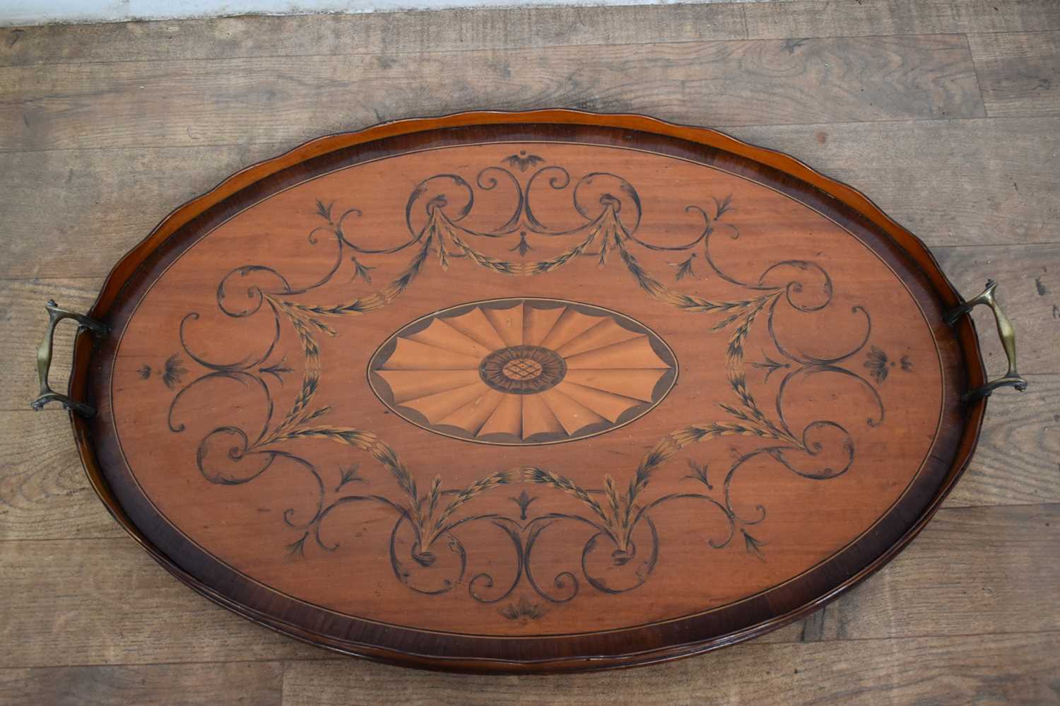 Lot 1301 - Adams style satinwood and marquetry inlaid oval tray with flanking brass handles, 69cm wide
