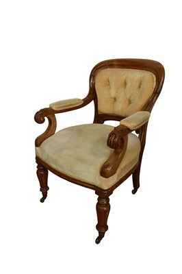 Lot 1236 - William IV mahogany library chair, with button upholstered back and seat and carved pad arms, raised on lappet carved supports and castors