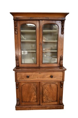Lot 1269 - Early Victorian mahogany secretaire bookcase with concave cornice and enclosed above by glazed doors, with fitted fall-front secretaire drawer and cupboards below on...