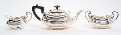 Lot 386 - Three piece teaset with gadrooned borders, on bun feet.
