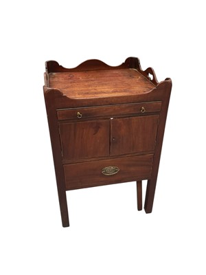 Lot 1309 - George III mahogany pot cupboard, with pierced undulating gallery and frieze drawer over enclosed cupboard, pull out pot drawer below, 57cm wide x 51cm deep x 84cm high