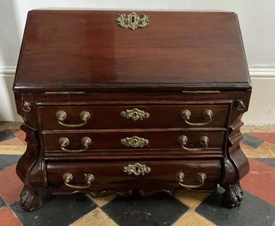 Lot 1270 - 18th century Dutch miniature mahogany bureau, with fitted interior and three graduated drawers to the bombe front on hairy paw feet, 54cm wide x 33cm deep x 43cm high