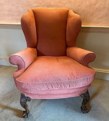 Lot 1267 - Georgian-style wing armchair on substantial carved cabriole legs with claw and ball feet, upholstered in terracotta fabric