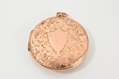 Lot 474 - Edwardian 9ct rose gold (back & front) circular locket with engraved decoration and double compartment to the interior, 35mm