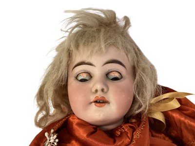 Lot 2055 - Armand Marseille bisque head, brown eyes, painted lashes, lips and brows, open mouth top four teeth showing. Composite body.